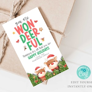 May include: A white Christmas gift tag with green and red text that reads "You are Won-Deer-Ful! Thank you for all that you do! Happy Holidays Love the Robinson Family". The tag features a cartoon illustration of two reindeer with red and white Santa hats in a green and red Christmas tree setting.