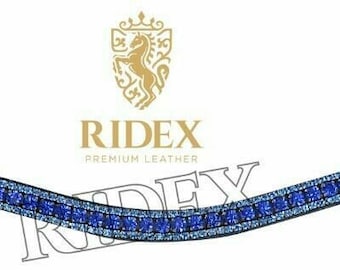 May include: A black leather browband with a row of blue rhinestones. The browband is curved and has the text "RIDEX PREMIUM LEATHER" printed on it.