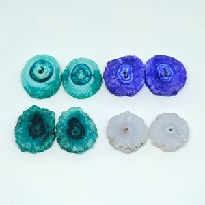 May include: Six agate slices in various colors and patterns. Two are blue, two are green, and two are white.
