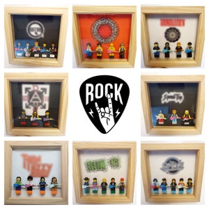 May include: Nine framed shadow boxes featuring miniature Lego figures of rock bands. Each frame displays a different band name and logo. The frames are crafted from wood and have a light brown finish.