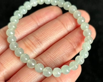 May include: A jade bracelet with light green round beads.