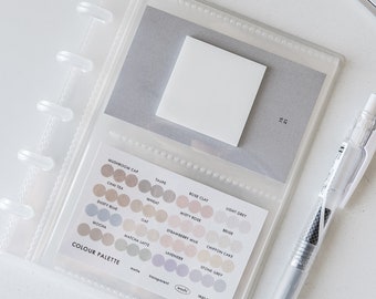 May include: A clear plastic binder with a color palette chart featuring 15 different shades of beige, pink, and purple. The chart is labeled "COLOUR PALETTE" and includes names for each color, such as "Mushroom Cap", "Chai Tea", "Taupe", and "Rose Clay".