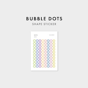 May include: A rectangular sticker sheet titled BUBBLE DOTS SHAPE STICKER featuring rows of small circular pastel-colored stickers in shades of green, purple, pink, blue, and yellow. The sheet includes the text DOTS, PASTEL, and 1521 STUDIO.