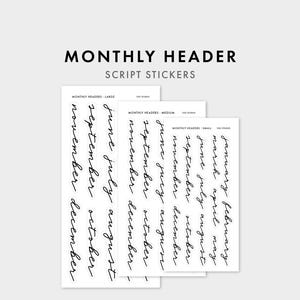 May include: Three white sticker sheets labelled MONTHLY HEADER SCRIPT STICKERS, featuring black cursive text for each month of the year in large, medium, and small sizes. The sheets are arranged in a cascading layout, displaying the months from January to December in a clean, minimalist font style.