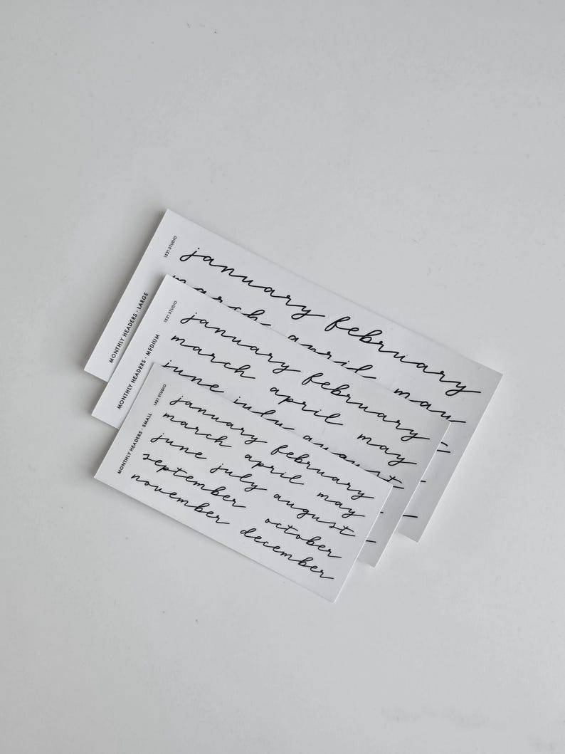 May include: Three white rectangular cards stacked vertically, each featuring black handwritten-style text listing months of the year. The cards are labelled Monthly Headers Large, Medium, and Small, with the text January through December printed in a lowercase script font.