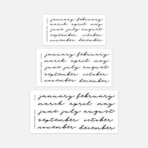 May include: Three sheets of black adhesive stickers featuring the months of the year in a cursive script font. Each sheet contains the months from January to December in small, medium, and large sizes, labelled as Monthly Headers.