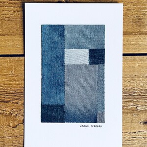 May include: A minimalist abstract art print featuring a geometric design made of different shades of blue denim fabric. The print is signed "Ioana Wede" in the bottom right corner.