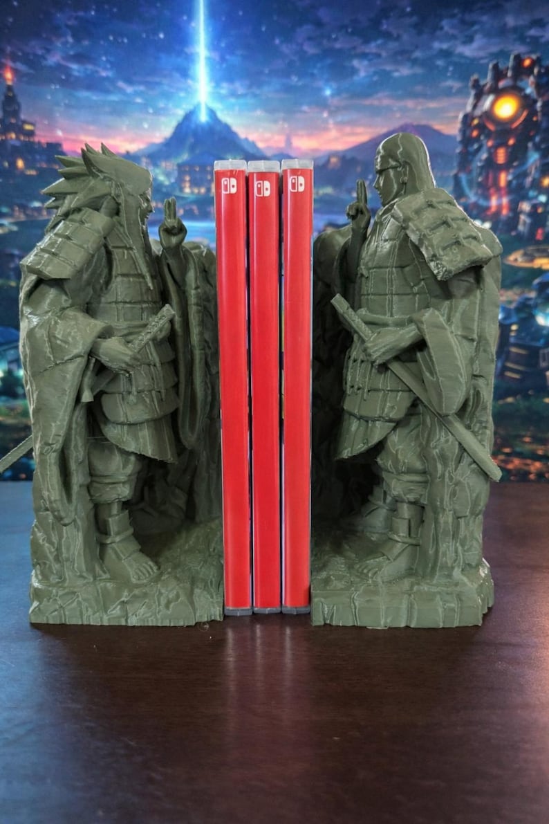 May include: Olive-green statue bookends, each depicting a figure in traditional dress, framing three red game cartridges. The background shows a blurred night sky and a cityscape.