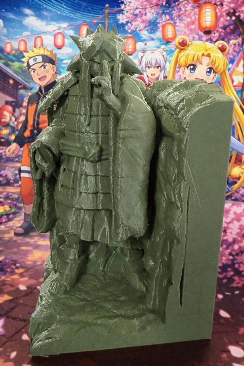 May include: A green figurine of a character in a traditional Japanese outfit, with a hand raised to the mouth. The figure is set against a backdrop of anime characters and a Japanese festival scene with lanterns and cherry blossoms.