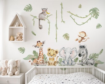 May include: A nursery wall decal set featuring a jungle theme with animals like a giraffe, lion, elephant, zebra, and monkey. The decals are in watercolor style and are perfect for a baby's room.