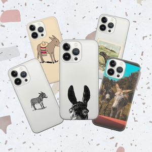 May include: Five different phone cases featuring donkey illustrations. The cases are white with a variety of donkey designs, including a donkey wearing a sombrero, a donkey with a floral pattern, and a donkey with a black and white pattern.