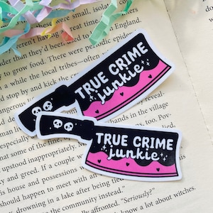 May include: Two black and pink stickers with a knife design. The stickers say "True Crime Junkie" with stars and hearts.
