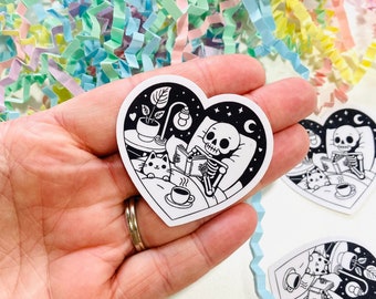 Cute Skeleton Reading a book Vinyl Sticker, Skeleton with cat, Spooky Reading, Bookish Heart Shape Sticker, Spooky Sticker, Kindle Stickers