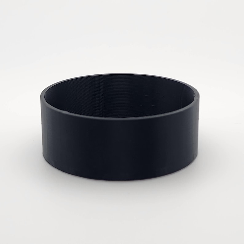 May include: A black, cylindrical, 3D printed coaster.