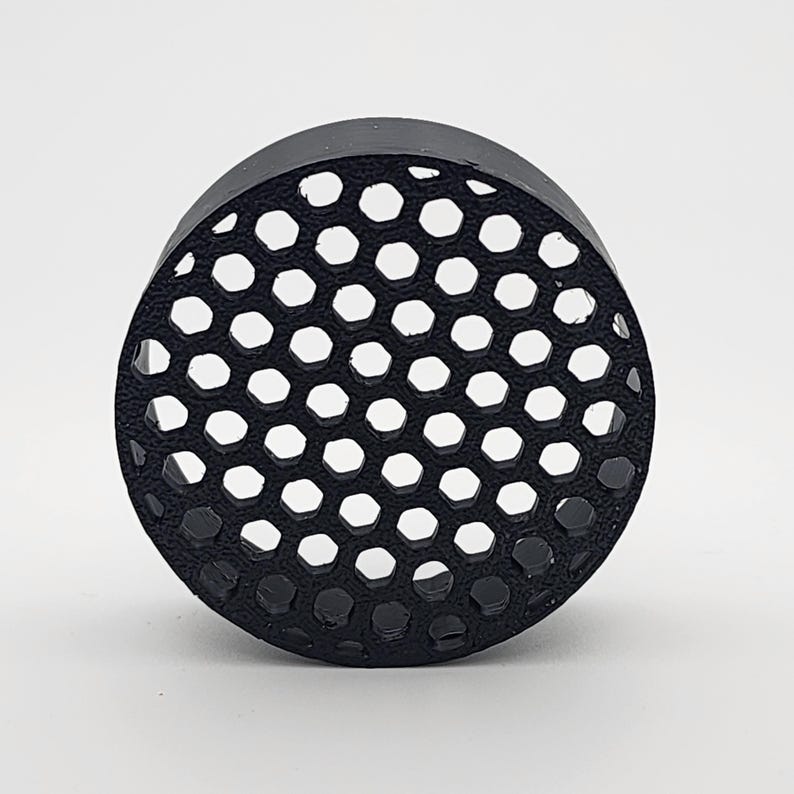 May include: Black round plastic filter with a honeycomb pattern.