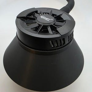 May include: A black, industrial-style device with a circular top featuring the text "hygger". The device has a flared, cone-shaped base and a flexible, curved tube extending from the top.