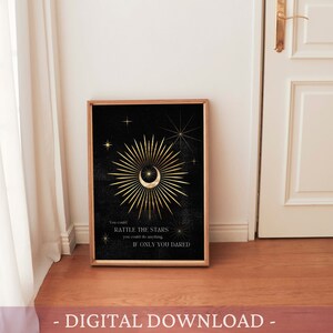 May include: A digital download of a printable art print featuring a gold crescent moon with a star inside, surrounded by a golden sunburst on a black background. The text "You could rattle the stars if only you dared" is below the moon.