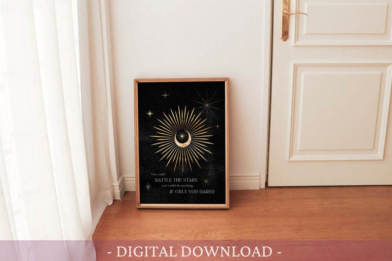May include: A digital download of a printable art print featuring a gold crescent moon with a star inside, surrounded by a golden sunburst on a black background. The text "You could rattle the stars if only you dared" is below the moon.