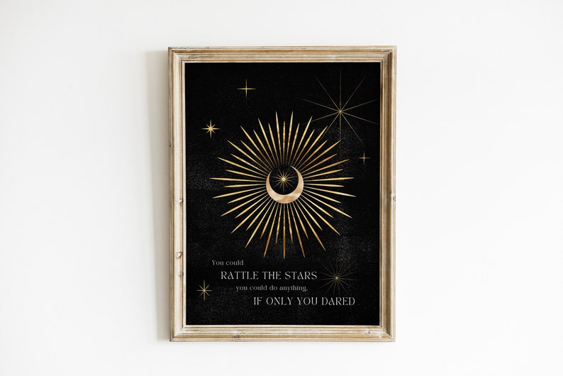 May include: A black and gold printable wall art print with a crescent moon and radiating sunburst design. The text reads "You could rattle the stars you could do anything if only you dared."