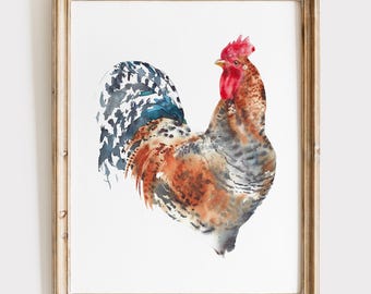 May include: A watercolor painting of a rooster with brown, gray, and black feathers and a bright red comb, enclosed in a light-colored wooden frame. The artwork features a white background and displays the bird in a side profile view.