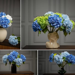 May include: Three arrangements of blue and white hydrangea flowers in different vases. The first vase is white ceramic, the second is a beige ceramic sculpture of a face, and the third is a dark green ceramic vase.