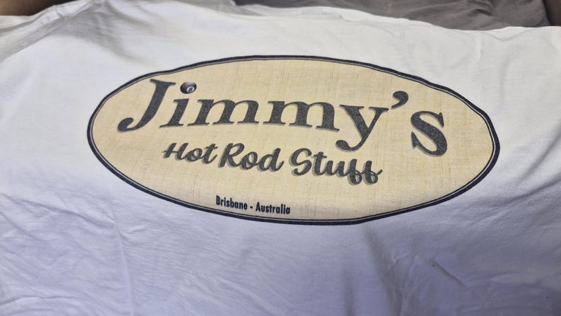 May include: White t-shirt with a tan oval logo that says "Jimmy's Hot Rod Stuff" and "Brisbane - Australia" in black text.