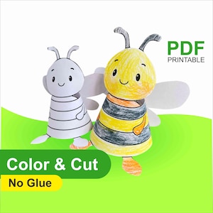 May include: Two paper bee crafts, one colored and one uncolored, with the text "PDF Printable", "Color & Cut", and "No Glue". The colored bee is yellow, black, and orange. The uncolored bee is white and gray.