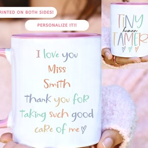 May include: White ceramic coffee mug with a pink rim and handle. The mug has a message that reads "I love you Miss Smith thank you for taking such good care of me" with hearts. The mug is being held by a hand. The text is in various pastel colors.