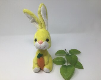 Vintage yellow, plushy, bobble head bunny, holding a carrot