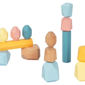 May include: A set of colorful wooden blocks in various shapes, including geometric shapes and rectangular blocks. The blocks are stacked in different configurations, creating a playful and creative scene.
