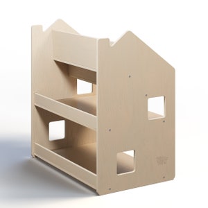 May include: A light wood bookshelf with three shelves and two cut-out windows. The bookshelf is shaped like a house.