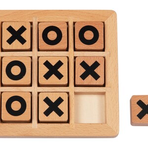 May include: A wooden tic-tac-toe game with nine squares. The squares are filled with wooden tiles that have either an 'X' or an 'O' printed on them. One tile is missing from the game.