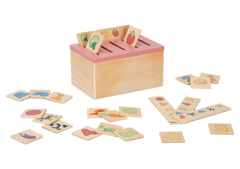 May include: Wooden box with a pink lid and slots for sorting cards. The cards feature images of fruits, vegetables, animals, numbers, and shapes.