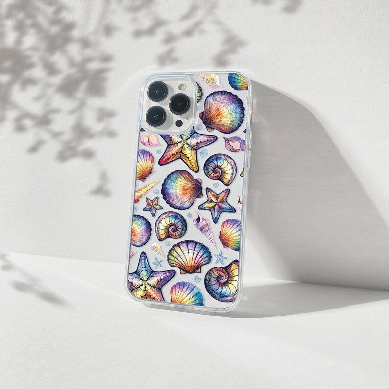 May include: A clear phone case with a colorful seashell and starfish design. The case is designed for an iPhone.