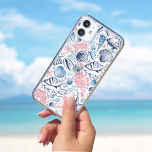 May include: A clear phone case with a white background and a pattern of blue and pink seashells, starfish, and coral.