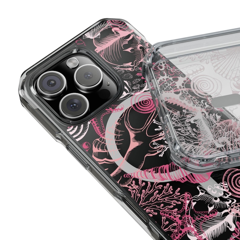 May include: A clear phone case with a black and pink design of sea creatures and swirls. The case is designed for an iPhone with a camera bump.
