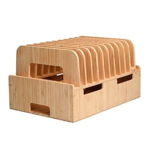May include: A wooden phone stand with multiple slots for charging and organizing phones. The stand is made of natural bamboo and has a light brown color.