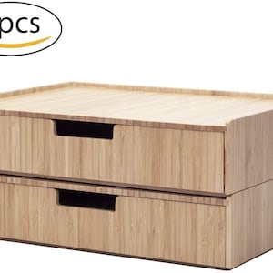 May include: Two-piece bamboo desk organizer with two drawers. The drawers have a natural wood grain finish and recessed handles. The top surface is flat. The text "2pcs" is in a white oval in the upper left corner.