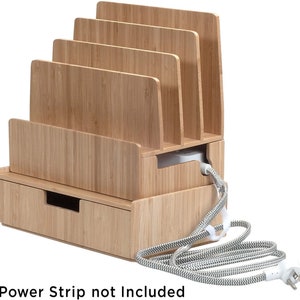 May include: Bamboo charging station with a drawer and slots for multiple devices. The charging station has a white power cord with a black and white striped cord cover. "Power Strip not Included" is written below the charging station.