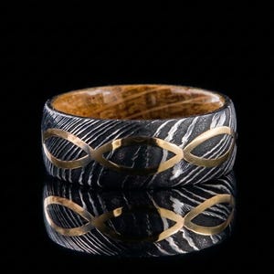 May include: A set of three ceramic mugs with a speckled, matte finish in cream, light grey, and dark grey. Each mug has a simple, minimalist design, ideal for coffee or tea.