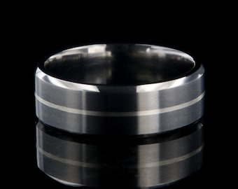 May include: A silver wedding band with a brushed finish and two thin white lines around the center.