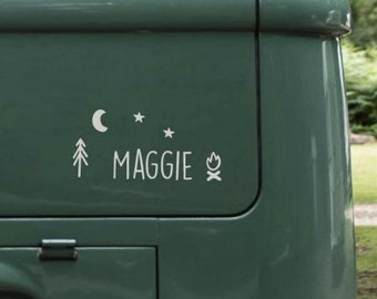 May include: A green van with a white decal that says "MAGGIE" with a moon, stars, a pine tree, and a campfire graphic.