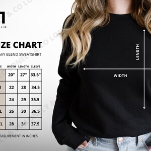 May include: Size chart for a heavy blend sweatshirt with measurements in inches for width, length, and sleeve length. Sizes include S, M, L, XL, and 2XL.