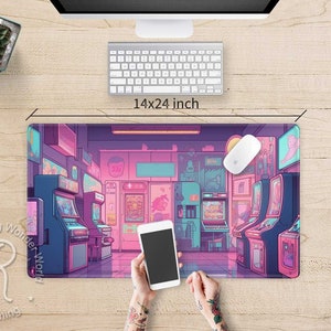 May include: A 14x24 inch gaming mouse pad featuring a colorful illustration of an arcade with retro game machines in shades of pink, blue, and purple. A white mouse and keyboard are on the wooden desk.