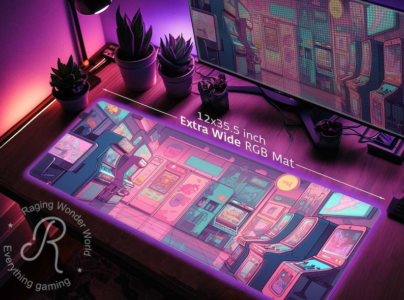 May include: An extra-wide RGB gaming mat, 12 x 35.5 inches, featuring a vibrant arcade game design in pink, purple, and blue hues. The mat has a neon-like border and includes the text "Extra Wide RGB Mat".