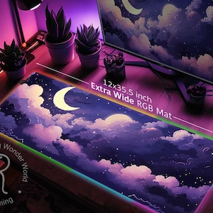 May include: A large, extra wide RGB gaming mousepad with a starry night sky design. The mousepad features a crescent moon and clouds in shades of purple, pink, and blue. The text "12x35.5 inch Extra Wide RGB Mat" is visible on the mousepad.