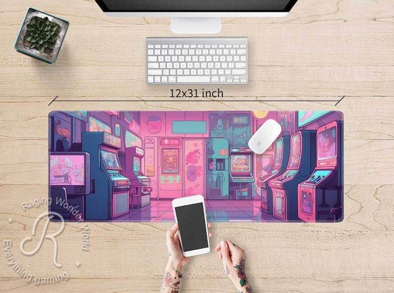 May include: A rectangular mouse pad featuring a vibrant arcade scene in shades of pink, blue, and purple. The pad measures 12x31 inches and depicts various arcade game machines. A white mouse and keyboard are visible above the pad.