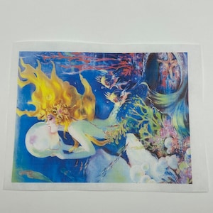 May include: A colorful illustration of a mermaid holding a large pearl underwater. The mermaid has long, flowing yellow hair and is surrounded by blue water, fish, and coral. The artwork has a vintage, fantasy style.
