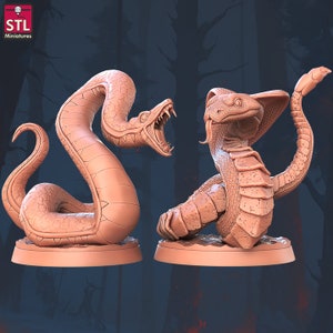 May include: Two 3D printed snake miniatures, one with its mouth open and the other with its head tilted back. Both snakes are a light brown colour and have detailed scales.