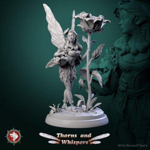 May include: A white painted miniature figurine of a fairy with wings, holding a small basket, standing on a base with a rose bush. The fairy is wearing a dress and has long hair. The base is decorated with leaves and flowers. The text "Thorns and Whispers" is printed below the base.